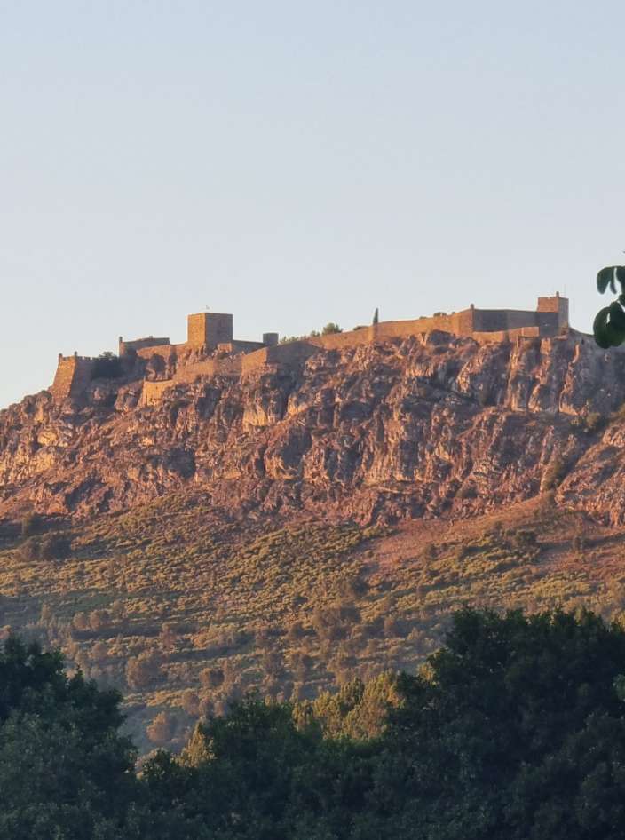 A vila muralhada de Marvão no cimo da serra, dourada ao fim do dia